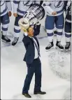  ?? JASON FRANSON — THE CANADIAN PRESS ?? Lightning head coach Jon Cooper hoists the Stanley Cup after defeating the Stars in the Stanley Cup Final on Monday in Edmonton, Alberta.