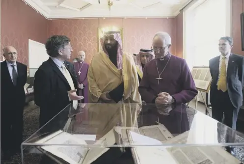  ??  ?? 0 Saudi crown prince Mohammed bin Salman and Archbishop Justin Welby examine early religious documents in Lambeth Palace