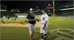  ?? CARLOS OSORIO — THE ASSOCIATED PRESS ?? Roger Clemens, seven-time Cy Young Award winning pitcher, left, shakes hands with his son, Kody Clemens, after the second game of a doublehead­er against the Minnesota Twins on Tuesday in Detroit. Kody made his debut with the Tigers in the major leagues.