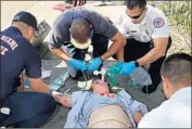  ?? C.M. Guerrero Miami Herald ?? MEMBERS of a Miami Fire Rescue crew work on a possible overdose victim in November.