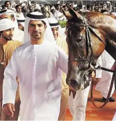  ?? Rex Features ?? Seventh heaven Emirati trainer Saeed Bin Surour leads in Prince Bishop, who gave him a seventh success in the Dubai World Cup.