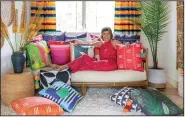  ?? (Photo courtesy of Spacecraft­ing) ?? Minneapoli­s designer Lucy Penfield at home with her colorful collection of new pillows for Missio Home.