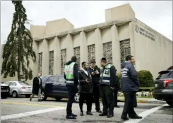  ?? MATT ROURKE — THE ASSOCIATED PRESS ?? Personnel from Chesed Shel Emes Emergency Services and Recovery Unit gather near the Tree of Life Synagogue in Pittsburgh, Sunday. Robert Bowers, the suspect in the mass shooting at the synagogue, expressed hatred of Jews during the rampage and told officers afterward that Jews were committing genocide and he wanted them all to die, according to charging documents made public Sunday.