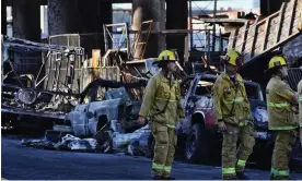  ?? Photograph: Richard Vogel/AP ?? Firefighte­rs assess the damage from an intense fire under Interstate 10 that severely damaged the overpass near downtown Los Angeles on 11 November.