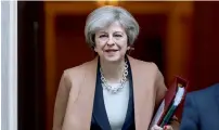  ?? — Reuters ?? Theresa May leaves 10 Downing Street to attend the weekly session of the House of Commons, in London, on Wednesday.