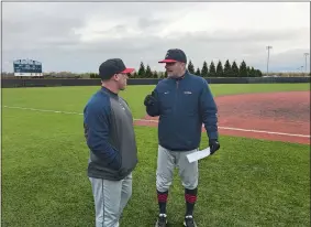  ?? GAVIN KEEFE/THE DAY ?? UConn head coach Jim Penders, right, chats with assistant coach Chris Podeszwa after Tuesday’s game at Rhode Island. The Huskies beat the Rams 5-4 and Penders tied Andy Baylock as the program’s career leader in wins with 556.