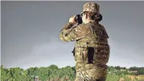  ?? PROVIDED BY THE NH NATIONAL GUARD ?? New Hampshire National Guard soldier Pfc. Macenzie Connors watches for illegal activity at an observatio­n point in Eagle Pass, Texas.