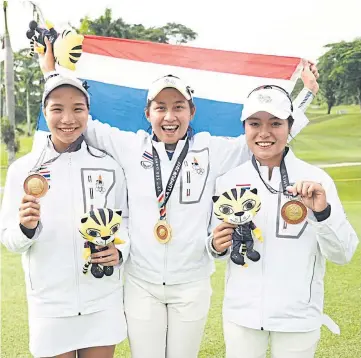  ??  ?? ABOVE Atthaya, centre, and her teammates celebrate with their team gold medals at the 2017 SEA Games.