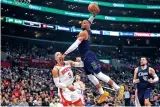  ?? MARK J. TERRILL/ASSOCIATED PRESS FILE PHOTO ?? Los Angeles Clippers guard Russell Westbrook, center, attempts a dunk as he hits Houston Rockets forward Dillon Brooks, left, during the first half of Friday’s game in Los Angeles.