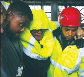  ?? AP/CARLOS GIUSTI ?? One of 19 municipal police officers arrives Wednesday at the Emergency Management Agency in Humacao, Puerto Rico, after being removed from a flooded police station by rescuers during Hurricane Maria, a Category 5 storm that hit the eastern region of...