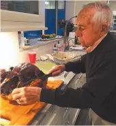  ?? FAMILY HANDOUT PHOTO ?? The author’s grandfathe­r, Phillip Layne, makes his first cut into the holiday turkey.