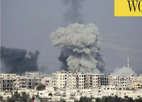  ?? ABDULMONAM EASSA / AFP / GETTY IMAGES ?? Smoke plumes rise above the rebel-held town of Hamouria, in the besieged Eastern Ghouta region on the outskirts of Damascus following a reported regime airstrike. Thousands of families are sheltering in basements in the area.