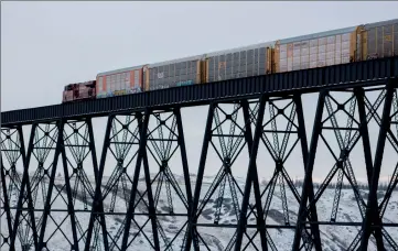  ?? Herald photo by Greg Bobinec ?? Canadian Pacific Rail reroutes large double-decker cargo cars along with dozens of other trains through Lethbridge following the derailment by Field, B.C., early Monday, which killed three crew members. @GBobinecHe­rald