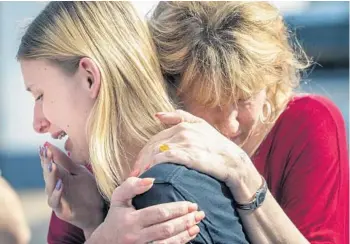  ?? STUART VILLANUEVA/AP ?? Santa Fe High School student Dakota Shrader is comforted by her mother, Susan Davidson, after Friday’s attack. Shrader said her friend was shot in the incident.