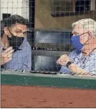  ?? Tony Gutierrez / Associated Press ?? Texas GM, left, talks with Ray Davis, who said he’s embarrasse­d by the results this season.