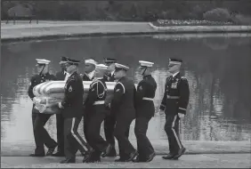  ?? SMILEY N. POOL/THE DALLAS MORNING NEWS ?? The flag-draped casket of President George H.W. Bush is carried to a burial plot close to his presidenti­al library for internment on Thursday in College Station, Texas.