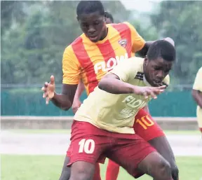  ?? PHOTO BY ASHLEY ANGUIN ?? Tyreke Clarke (front) from St James High is being tackled by Garnet Hudson of Cornwall College during the DaCosta Cup match at the Catherine Hall Stadium in Montego Bay on Saturday, September 16.