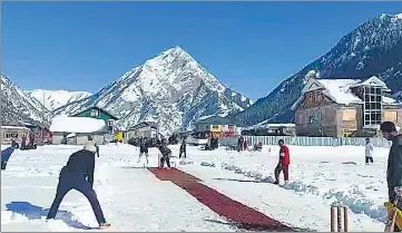  ?? ANI ?? Locals play cricket on a snow-covered ground in Gurez, Bandipore, on Thursday.