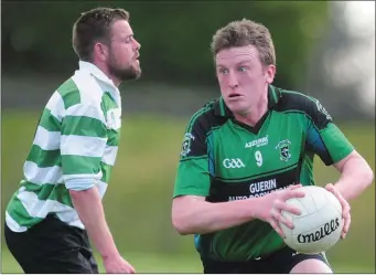  ??  ?? A determined Joe Collins sets up a Glenlara attack against Ballinure in the Co. JCFC at Carrigadro­hid Photo by John Tarrant