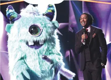  ??  ?? The monster and host Cannon in ‘The Masked Singer’. — Courtesy of Fox
