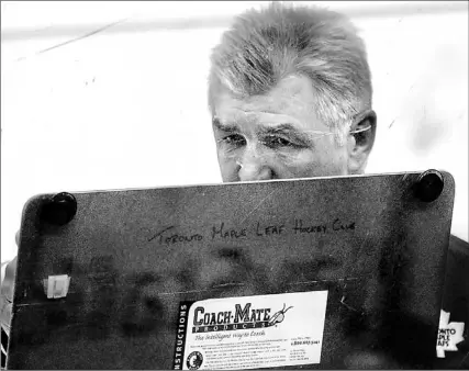  ?? RICHARD LAUTENS/TORONTO STAR ?? Maple Leafs coach Pat Quinn goes to his diagram board to explain some strategy to his players during a practice session yesterday. The Leafs, who are on a four-game win streak, take on the Boston Bruins, whom they beat 4- 1 last week. Boston has lost...