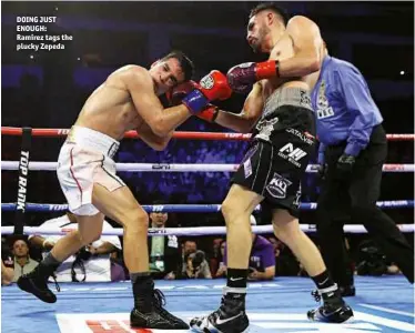  ?? Photo: MIKEY WILLIAMS/TOP RANK ?? DOING JUST ENOUGH: Ramirez tags the plucky Zepeda