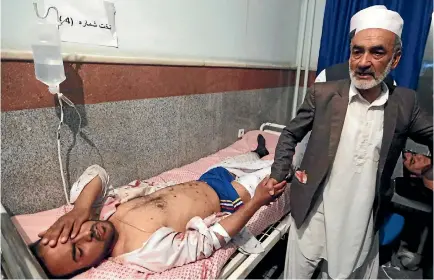  ?? PHOTO: REUTERS ?? An injured man receives treatment at a hospital after an attack at a mosque in Herat, Afghanista­n, where a man killed 29 worshipper­s during evening prayers.