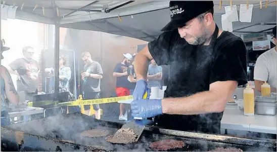  ?? Photograph­s by Gary Coronado Los Angeles Times ?? SHAWN NEE, creator of Burgers Never Say Die, cooks patties during a pop-up appearance. He used to not eat red meat, but now he specialize­s in preparing it.