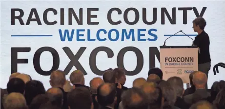  ?? MARK HOFFMAN / MILWAUKEE JOURNAL SENTINEL ?? Jenny Trick, executive director of Racine County Economic Developmen­t Corp., announces the location of the Foxconn plant during a news conference Oct. 4 at the S.C. Johnson iMET Center in Sturtevant.
