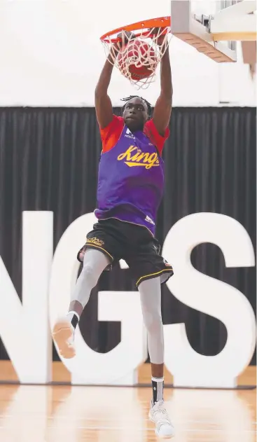  ?? Picture: Brett Costello ?? TOWERING POTENTIAL: Deng Acouth shows his innate talent as he dunks a basket during training at Qudos Bank Arena, Homebush.