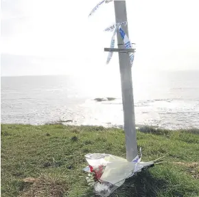  ?? Picture: Mhairi Edwards. ?? Flowers left at Arbroath cliffs yesterday.