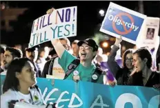  ?? Frank Franklin II/Associated Press ?? Protesters gather before the presidenti­al debate.