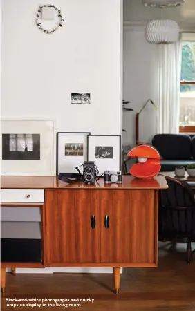  ??  ?? Black-and-white photograph­s and quirky lamps on display in the living room