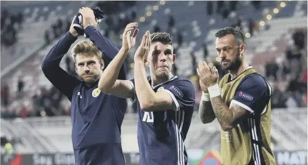  ?? PICTURE: ADAM DAVY/PA ?? 0 Flanked by Stuart Armstrong and Steven Fletcher, Ryan Christie applauds the travelling Scotland supporters at the end of Saturday’s 4-0 win.