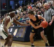  ?? RANDY MEYERS — FOR THE MORNING JOURNAL ?? Eric Hanna of Olmsted falls looks at the defense by Seth Wilson of Akron St. Vincent-St.Mary during the second quarter of a regional semifinal March 13.