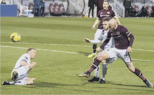  ??  ?? 0 Liam Boyce scores the first of his three goals as he fires high into the net to give Hearts the lead at Tynecastle last night