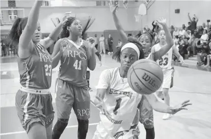  ?? KARL MERTON FERRON/BALTIMORE SUN ?? Roland Park’s Jeydah Johnson (23), Christyn Robinson (41) and Ja’Niah Henson guard Seton Keough’s Summer Fields (1), who can’t get off a shot as time expires. The Gators got the ball back with 7.6 seconds remaining, but Sydney Mitchell missed a final...