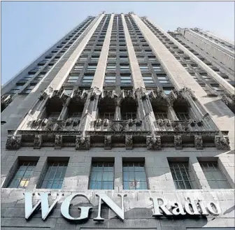  ?? Kiichiro Sato Associated Press ?? THE WGN RADIO sign appears on the side of Tribune Tower in downtown Chicago. Sinclair Broadcast Group is paying $3.9 billion to acquire 42 stations from Tribune. Approval is still months away.