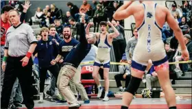  ?? NATE HECKENBERG­ER - FOR MEDIANEWS GROUP ?? At left, the Spring-Ford wrestling team poses after winning Saturday’s District 1-AAA duals championsh­ip. At right, Spring-Ford coach Tim Seislove celebrates after Xavier Cushman’s dual-clinching pin at 160 pounds at Saturday’s District 1-AAA duals championsh­ip.