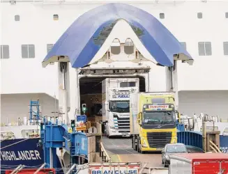  ?? Peter Morrison/Associated Press ?? Freight trucks arrive from Scotland at Larne Port, Northern Ireland, on Monday.