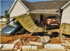  ?? BRANDON DILL/THE NEW YORK TIMES ?? A home and vehicles damaged by flooding is seen in Waverly, Tenn., Aug. 24.