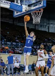  ??  ?? Photo By: Aaron Witt Karson Neville going in for the layup.