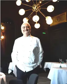  ??  ?? French chef Guy Savoy poses in the dining room of his Michelin three-starred restaurant ‘Restaurant Guy Savoy’ in the Monnaie de Paris, in Paris.