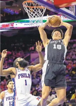  ?? LAURENCE KESTERSON AP ?? Spurs forward Isaiah Roby grabs a rebound away from 76ers guard James Harden in the first half Saturday in Philadelph­ia. The Sixers are 0-3 to start season.