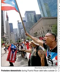  ?? Bloomberg News/PETER FOLEY ?? Protesters demonstrat­e during Puerto Rican debt talks outside Citibank Inc. headquarte­rs on Park Avenue in New York on July 13.