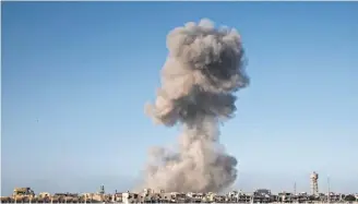  ?? FABIO BUCCIARELL­I, AFP/ GETTY IMAGES ?? Smoke rises after an airstrike on Sirte, Libya, the last stronghold of Islamic State last September. The air campaign is considered amodel for future operations in the region, said Marine Gen. ThomasWald­hauser.