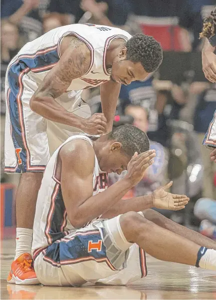  ?? | AP ?? Illinois’ Malcolm Hill ( seated on court) reacts after being fouled while making a shot during the second half Tuesday against IUPUI.