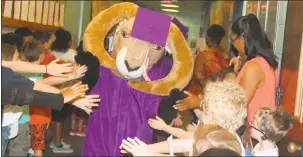  ?? STAFF PHOTO BY JAMIE ANFENSON-COMEAU ?? Maurice J. McDonough mascot Rammy the Ram and members of the Class of 2016 are greeted by students at Dr. James Craik Elementary School. McDonough seniors took a “Parade of Success” to area schools.