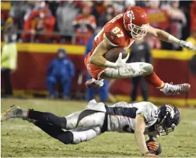  ??  ?? KANSAS CITY: Kansas City Chiefs tight end Travis Kelce (87) vaults Denver Broncos safety Justin Simmons (31) during the second half of an NFL football game in Kansas City, Mo., Sunday. — AP