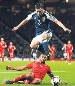  ?? Pictures: SNS/Getty. ?? Top: Christophe Berra races away after opening the scoring; above: former Dundee United defender Andy Robertson jumps over a challenge by Steve Borg.